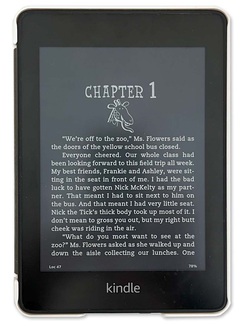 Close up of Kindle e-reader showing Dark Mode display of black background with white text.